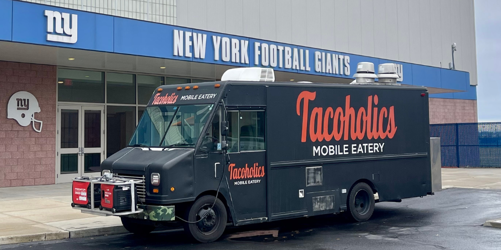 Black Tacoholics Mobile Eatery food truck catering a corporate event at the New York Football Giants training facility.